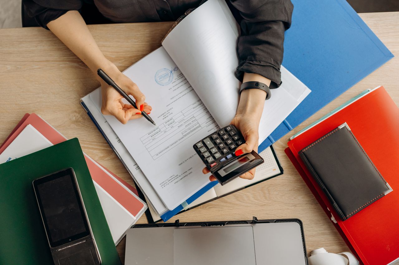 Mastering the First Impression: Your intriguing post title goes here Accountant analyzing financial documents with a calculator on a desk, highlighting business tasks.
